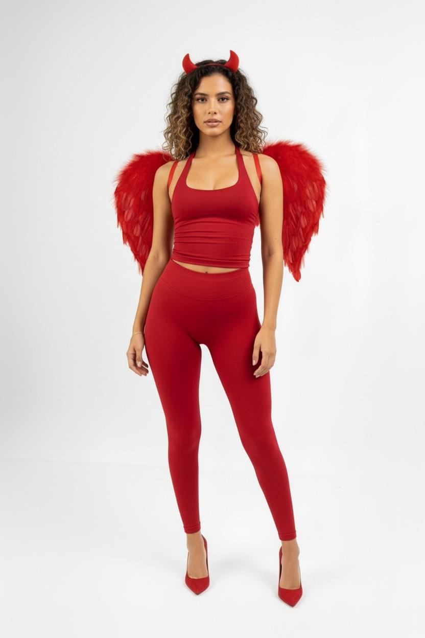 דוגמנית בסט ספורט אדום של YARA בתחפושת שטן עם קרניים וכנפיים אדומות.